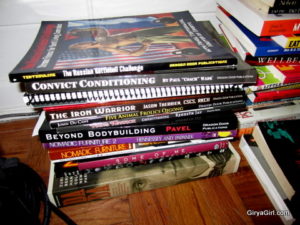 Big stack of books on a wood floor