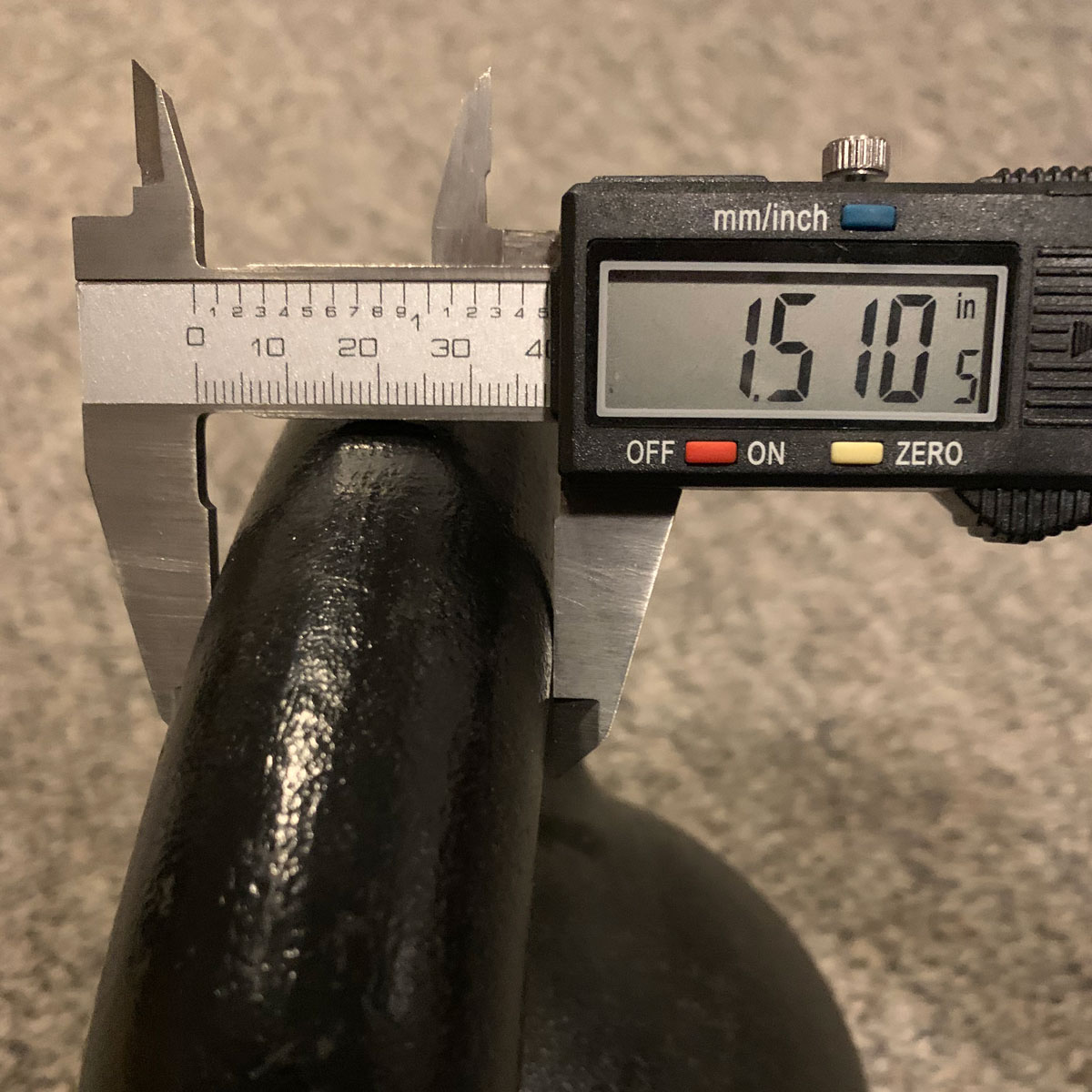 measuring the diameter of a Dragon Door Kettlebell handle with digital calipers in inches